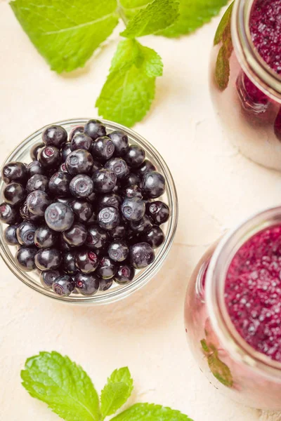 Taze yeşil nane yaprakları ve ham Olgun meyveleri yaz karışımlı vitamini kopya alanı ile kokteyl şeffaf kavanoz sarı pastel arka planda - Blueberry smoothie süslenmiş.