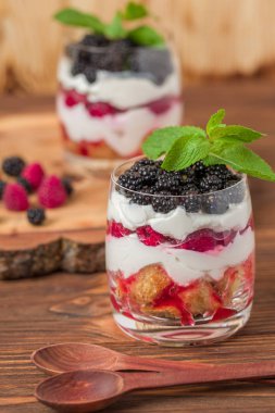 Önemsememek yakın taze multi fotoğrafla kadar tatlı süt ve olgun ahududu ve böğürtlen ahşap arka plan - meyve organik sağlıklı yemekle tatlı üzerinde katmanlı.