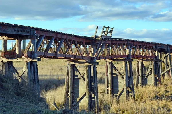 Old abandoned wooden railway bridge over the Boorowa River, in rural central west NSW, Australia