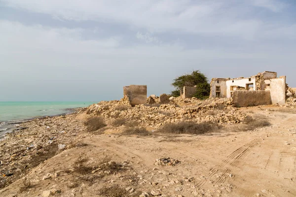 Ruined ancient old Arab pearling and fishing town Al Jumail, Qatar. The desert at coast of Persian Gulf. Deserted village on the beach of sea. Middle East, Asia-Africa.