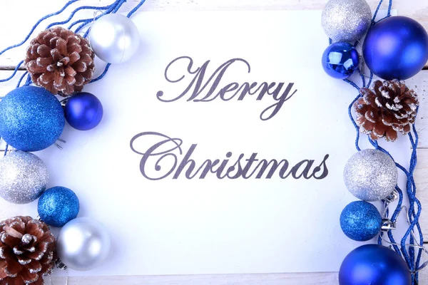 Text merry christmas on paper with many balls — Stock Photo, Image