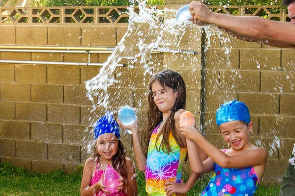 Arms Father Break Blue Water Balloon Heads His Three Daughters — Stock Photo, Image