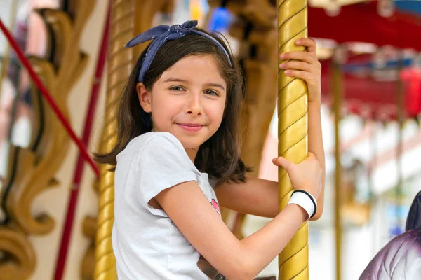 Happy Young Girl Smiles Confidentally While Sitting Carousel Holding Pole — Stock Photo, Image