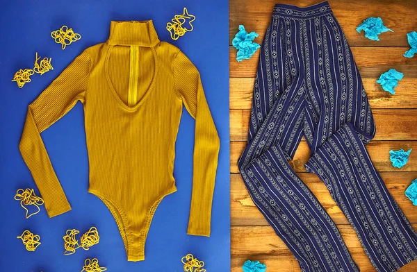 Beautiful unusual outfit presentation for fashion blog, advertising, clothing catalog. Mustard bodysuit with a cutout and light blue patterned pants. Dried roots and paper decor.