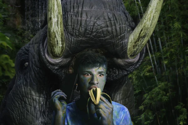 huge animal with large tusks, is about to attack a jaunted tourist in the jungle, the concept