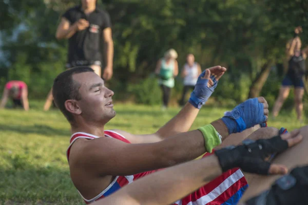 Athletes perform gymnastic exercises in outdoor sports training