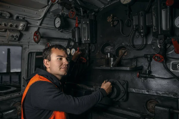 locomotive driver in the workplace in the cabin of the locomoti