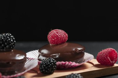 Ahududu ve böğürtlen ile ev yapımı çikolatalı kekler olmak