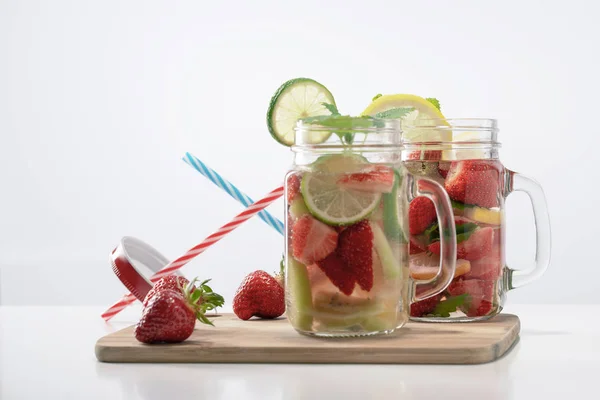Dos tazas de agua de frutas con fresas menta y limón stand o — Foto de Stock