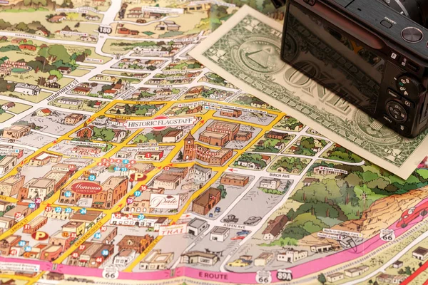 Detail of travel map Flagstaff, Arizona, USA with camera and one Dollar bill — Stock Photo, Image