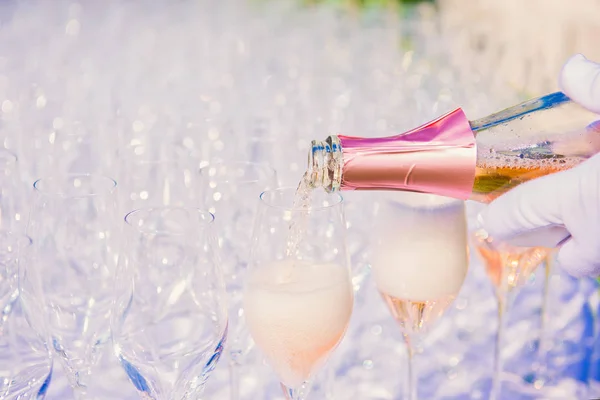 Waiter pouring champagne, sparkling wine