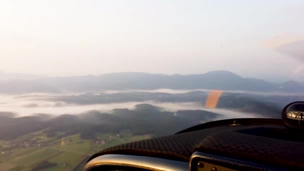 Aerial view of misty landscape from the cockpit of small propeller airplane — Stock Video