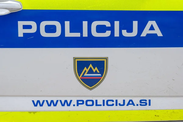 Police sign with emergency dial number on the side of patrol car — Stock Photo, Image