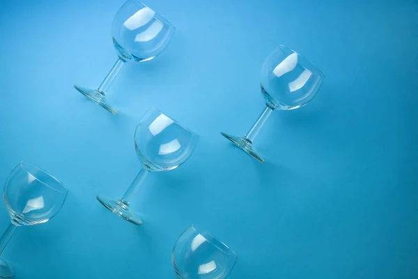 Pattern with wine glasses on pastel blue background