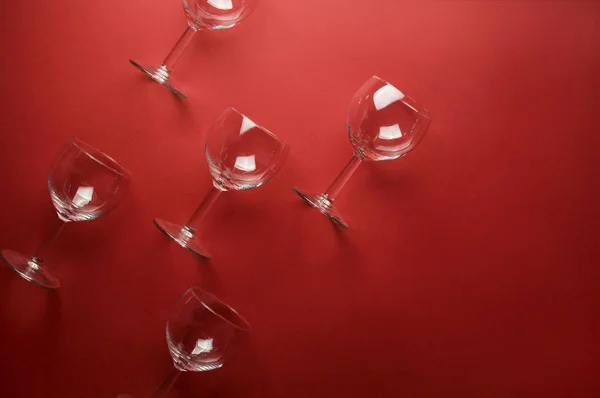 Pattern with wine glasses on deep red background