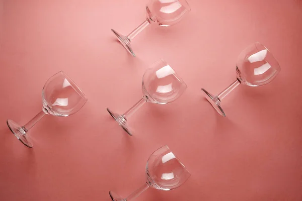Pattern with wine glasses on pastel pink background