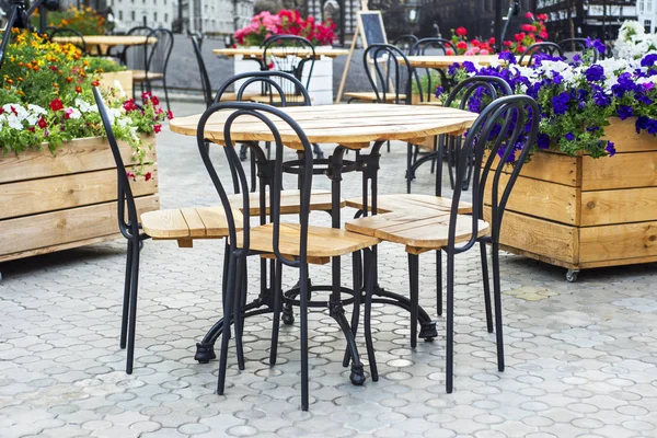 Cafe with tables and chairs in street