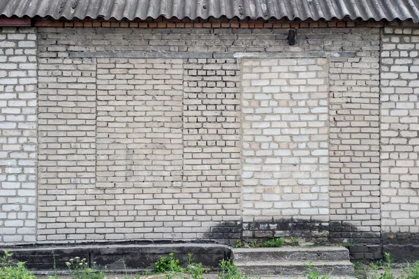 brick wall with bricks laid down doors and window