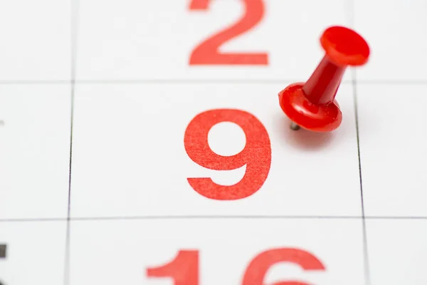 Pin on the date number 9. The ninth day of the month is marked with a red thumbtack. Pin on calendar