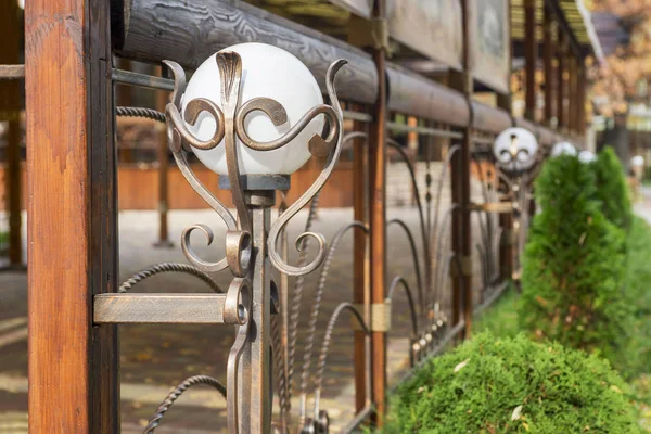 Decorative lanterns along the street cafe barrier. Front of street cafe. Modern european cafe