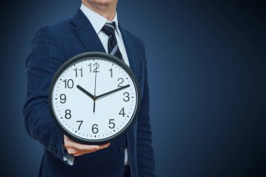 İş adamı elinde saat. Bir saat içinde bir el ile bir iş adamı. Saati zaman kavramı ile işadamı