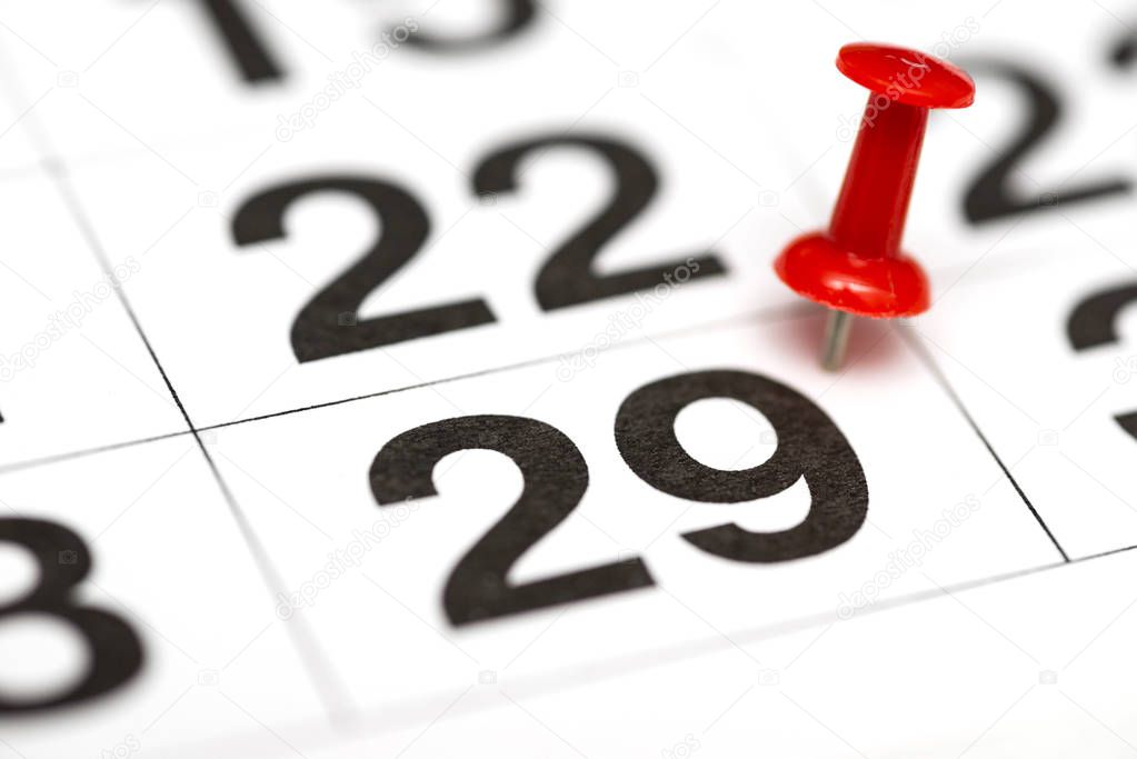 Pin on the date number 29. The twenty ninth day of the month is marked with a red thumbtack. Pin on calendar