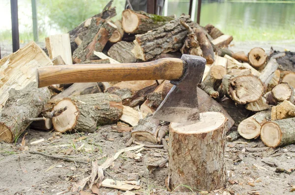 Axe in stump. Axe ready for cutting timber.Woodworking tool. Lumberjack axe in wood, chopping timber. Travel, adventure, camping gear, outdoors items