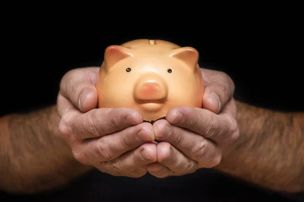 Man with piggy bank in hand. Man is holding a piggy bank in his hands for a money or finance concept — Stock Photo, Image