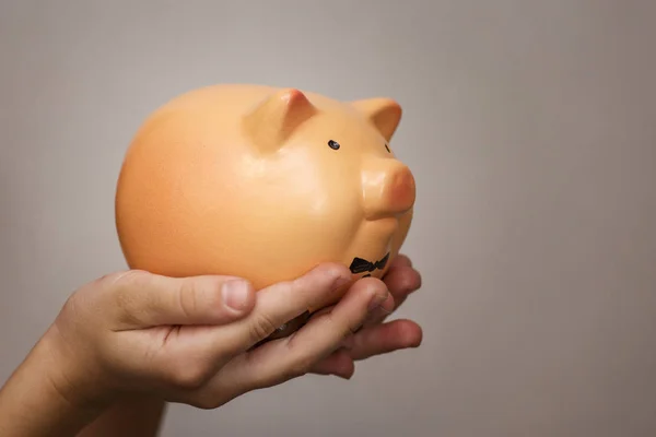 Kid hold a pig bank, a saving money for future education concept. Little girl holding a piggy bank
