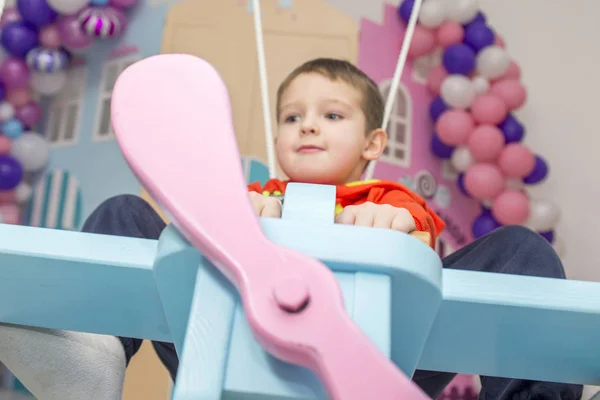 Chlapec si představuje sám sebe jako pilota letadla v dětském pokoji — Stock fotografie