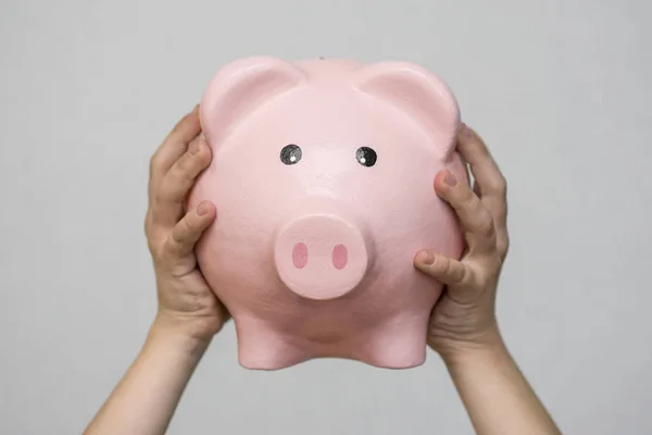 Little kid holding piggy bank, closeup. Piggy bank in hand. Money savings concept — Stock Photo, Image