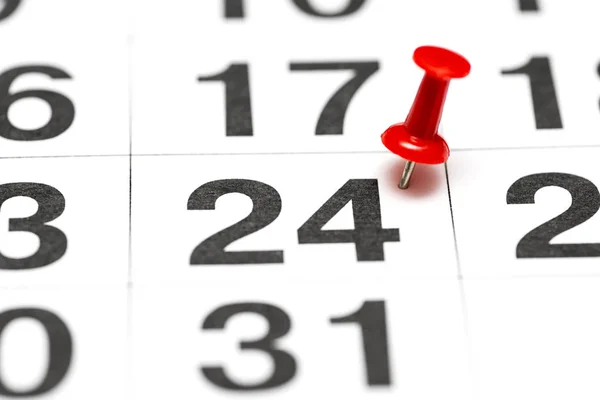 Pin on the date number 24. The twenty fourth day of the month is marked with a red thumbtack. Pin on calendar