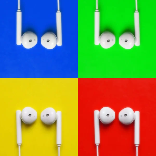 Bílá sluchátka na barevném kreativním pozadí. Moderní barevná fotka. Horní pohled — Stock fotografie