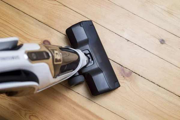 Vacuum cleaner on the wooden floor. Vacuum cleaner on the floor showing house cleaning concept