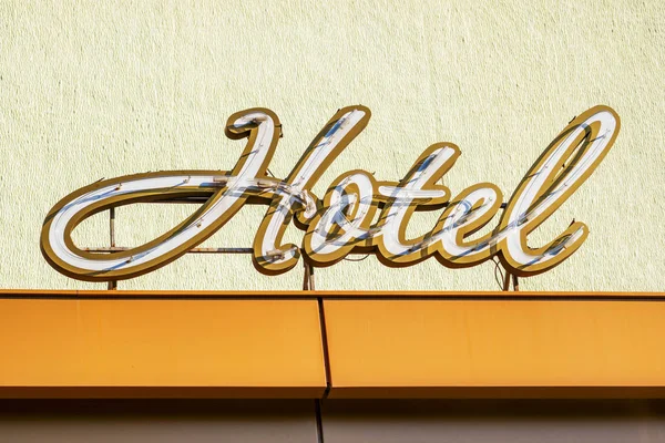 Signboard of a hotel. Hotel word with golden letters on hotel — Stock Photo, Image