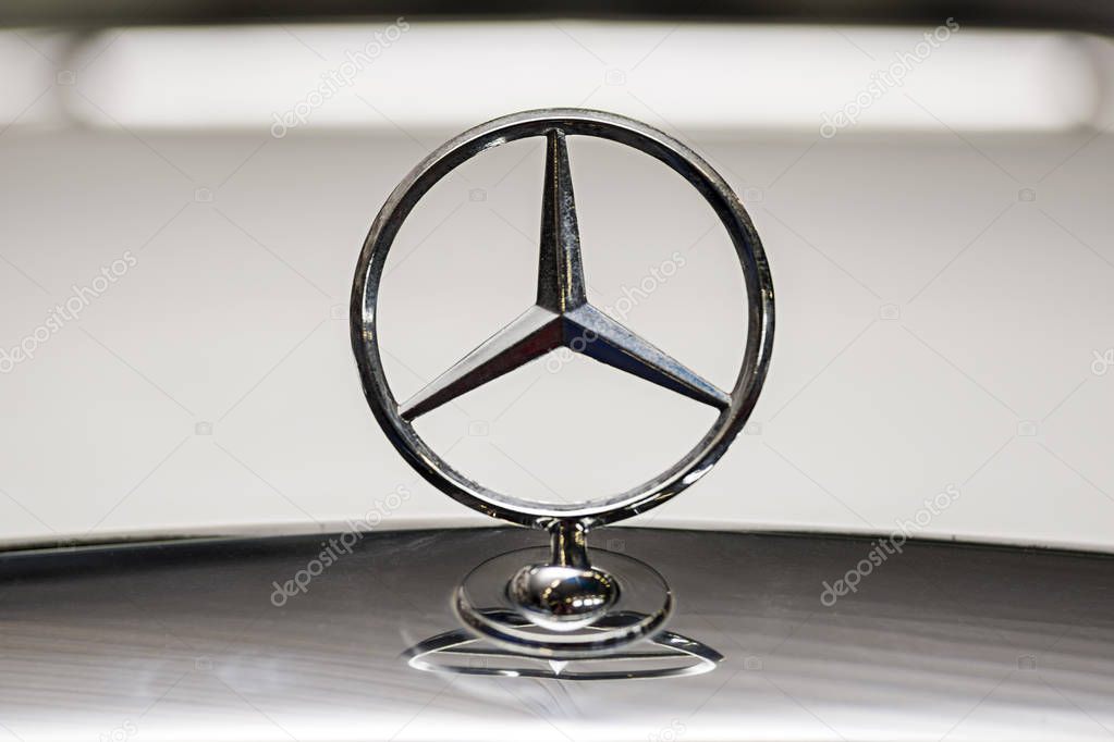 Zaporozhye, Ukraine - October 04, 2019: Mercedes Benz sign on the hood of a black vehicle, close-up. Space for text.