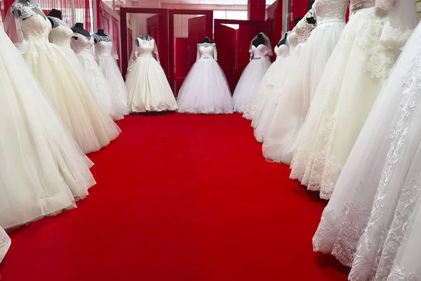 Collection of wedding dresses in the shop. Wedding dresses in a shop. Beautiful wedding dresses on a mannequins
