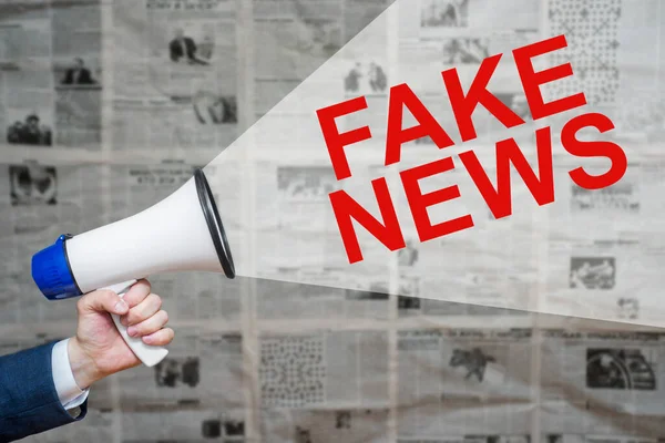 Man Hand Holding Megaphone Speech Bubble Fake News Newspapers Background — Stock fotografie