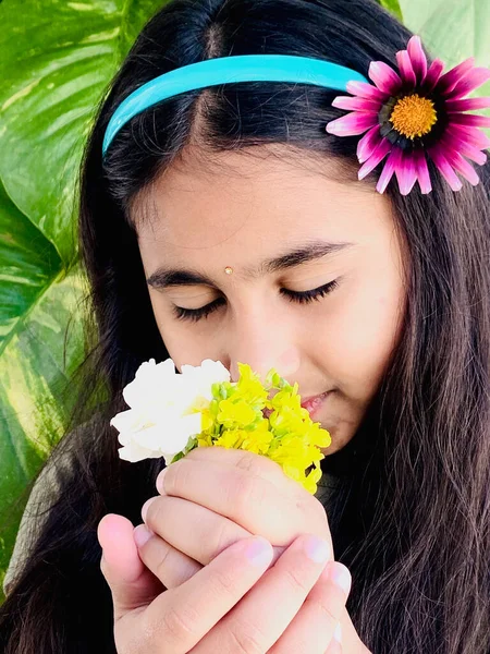  Elinde çiçekle Hintli bir kız çocuğu