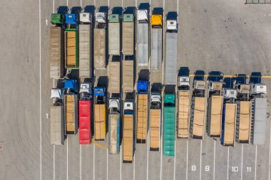 Storage area for trucks on the territory of the grain terminal. View from above. Aerial photography. clipart