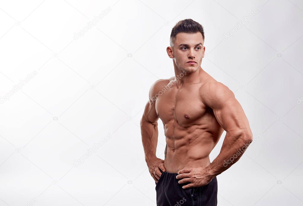 Bodybuilder man with perfect abs, shoulders,biceps, triceps and chest, personal fitness trainer. Unrecognizable Strong bodybuilder. 