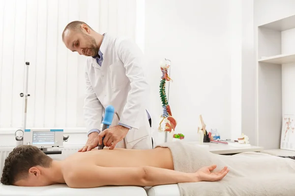 Extracorporeal Shockwave Therapy ESWT cerrahi olmayan tedavi. Boyun ve sırt kasları için fizik tedavi, şok dalgalarıyla omurga. Ağrı kesici, normalleşme ve yenilenme, canlandırma işlemleri, canlandırma süreci. — Stok fotoğraf