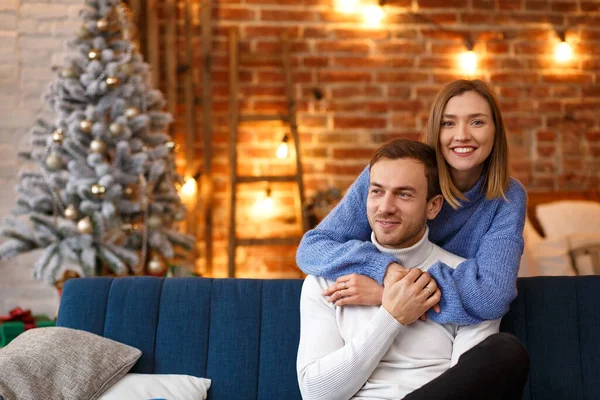 Портрет красивой улыбающейся пары, обнимающейся в канун Рождества. Прекрасная молодая пара дома наслаждается проведением времени вместе. Зимние праздники, рождественские праздники, новогодняя концепция — стоковое фото