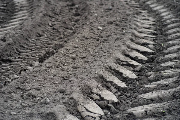 trail on the field. Track of a tractor on a plowed field