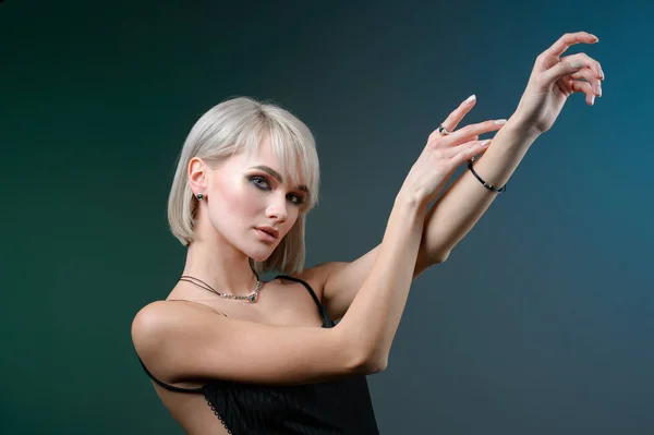 Beautiful woman in necklace, earrings and ring. Model of silver and semiprecious stones