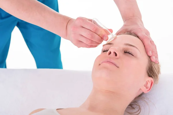 Young Woman receives facial cupping massage facial rejuvenation