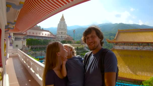 Slowmotion shot of a family shooting selfie while visiting the Kek Lok Si temple on Penang island, Malaysia. — Stock Video