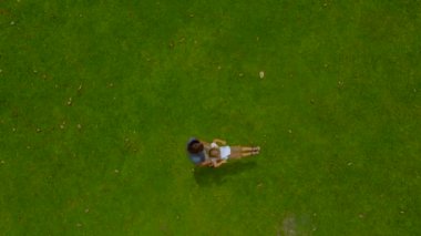 Bir baba oğlu yeşil çim üzerinde onun kollarında çember hava slowmotion vurdu. Kamera iner