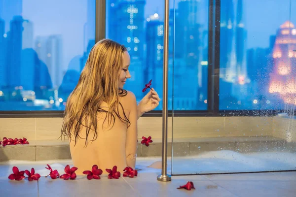 Young Woman Sits Bath Foam Frangipani Flowers Background Panoramic Window — Stock Photo, Image