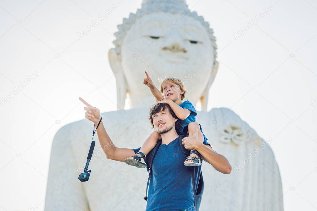 Father and son tourists on the Big Buddha statue. Was built on a high hilltop of Phuket Thailand Can be seen from a distance. Traveling with children concept.